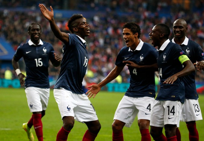 France's Pogba celebrates with team mates after scoring against Portugal during their friendly soccer match at the Stade de France in Saint-Denis